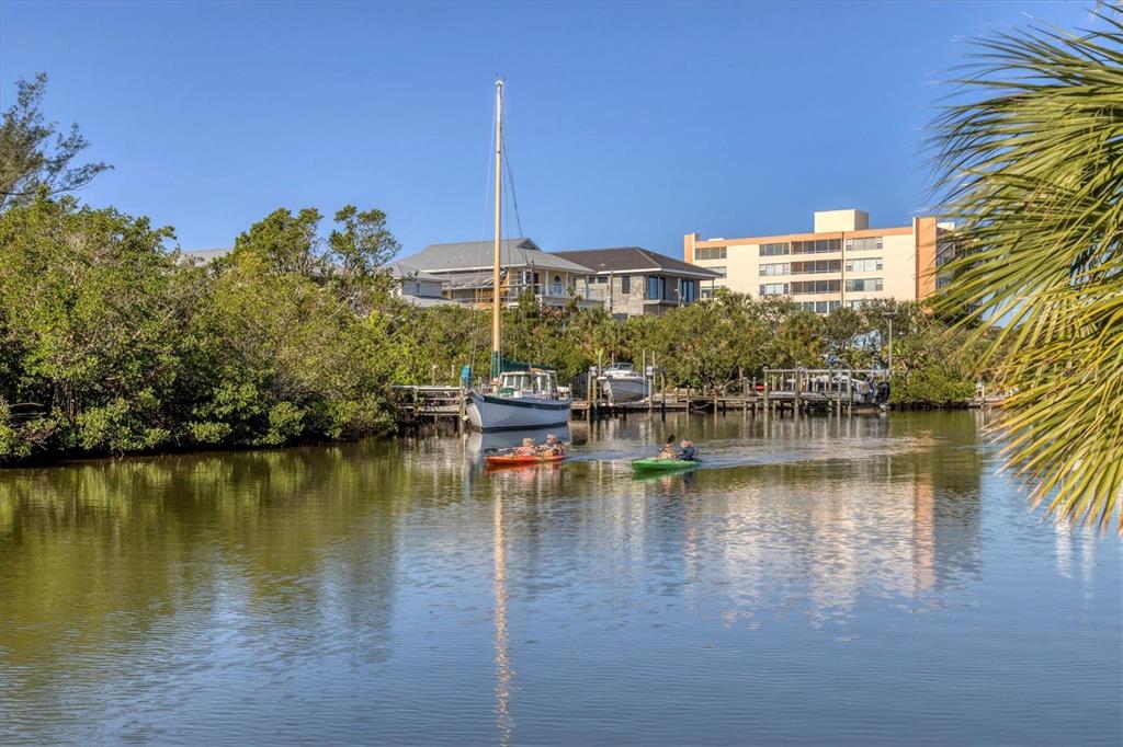 9393 Midnight Pass Road, Unit 302 Sarasota, FL 34242 - Photo 50 of 65 a view of an ocean with palm trees