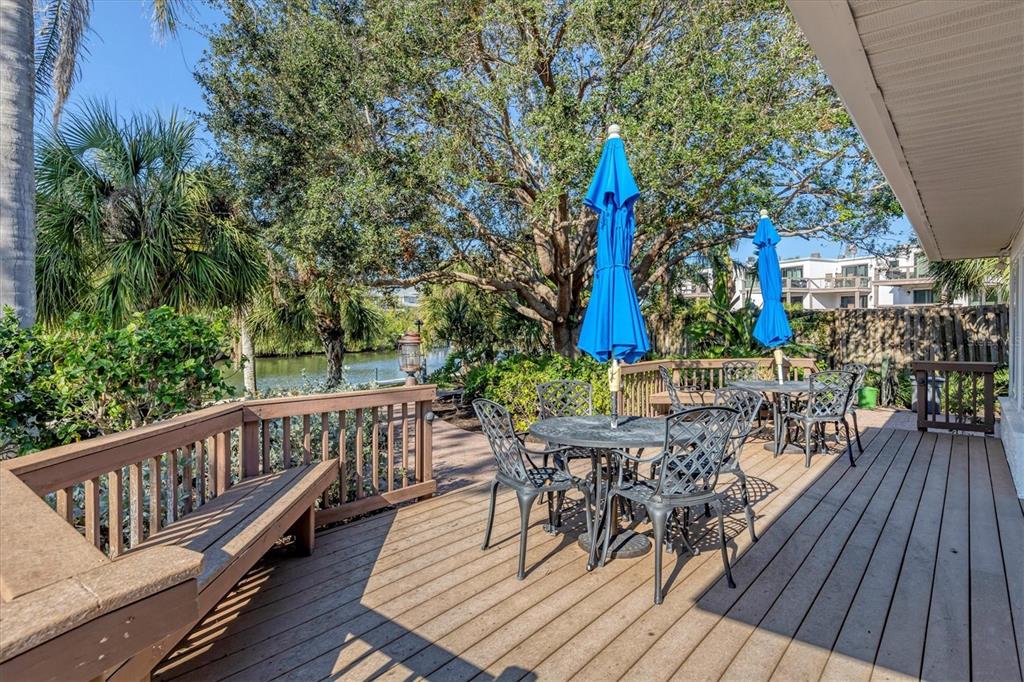 9393 Midnight Pass Road, Unit 302 Sarasota, FL 34242 - Photo 52 of 65 a view of balcony with wooden floor and outdoor seating