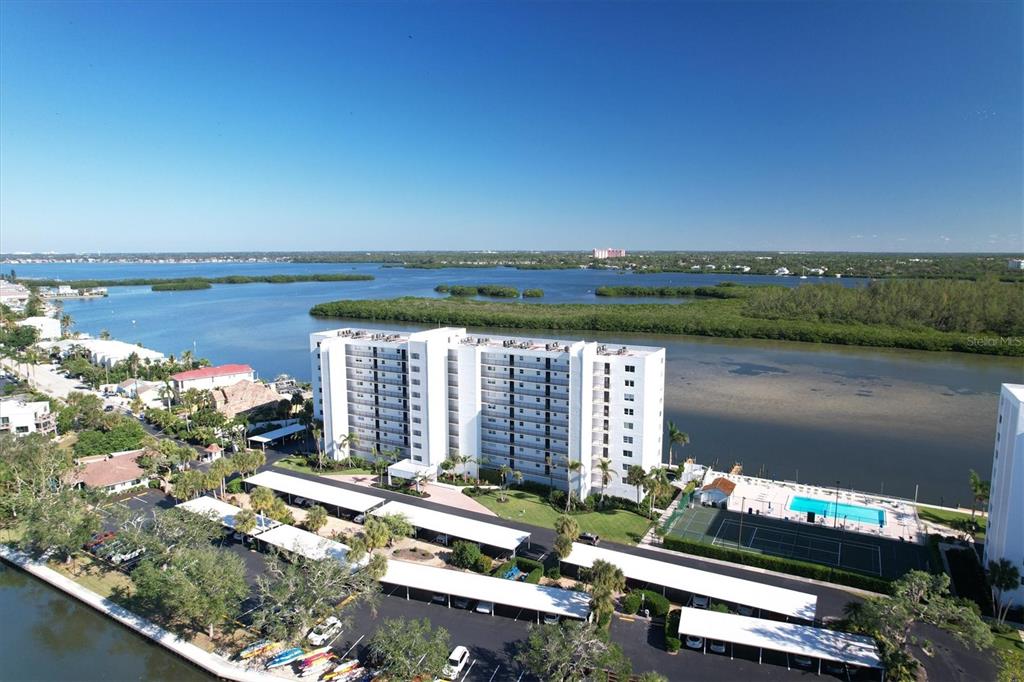 9393 Midnight Pass Road, Unit 302 Sarasota, FL 34242 - Photo 61 of 65 a view of a lake with a city view