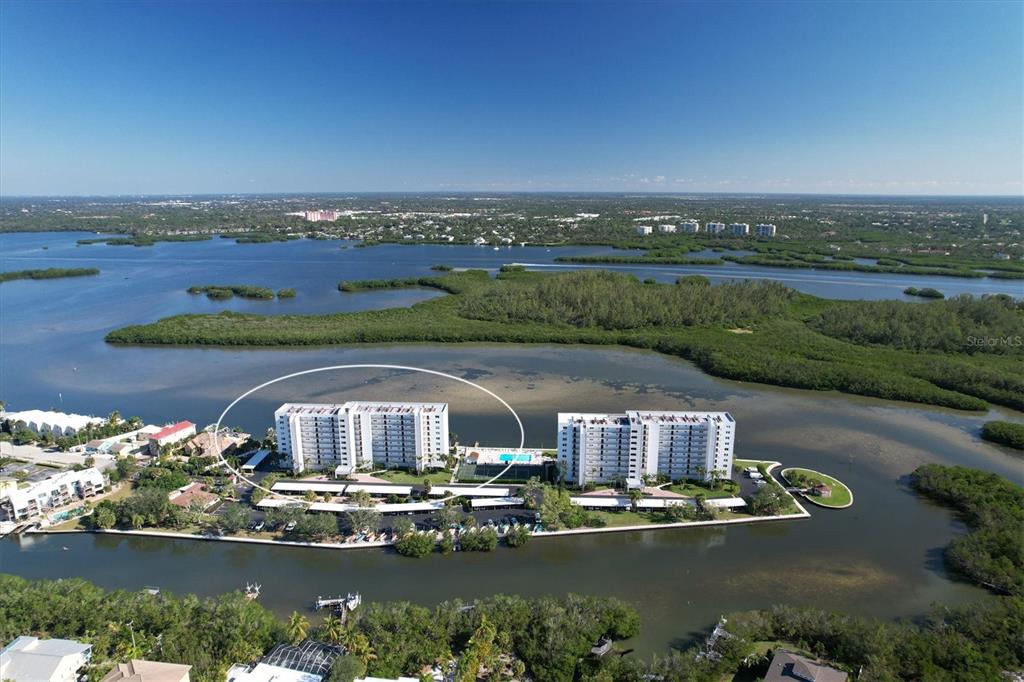 9393 Midnight Pass Road, Unit 302 Sarasota, FL 34242 - Photo 63 of 65 an aerial view of a house with a lake view