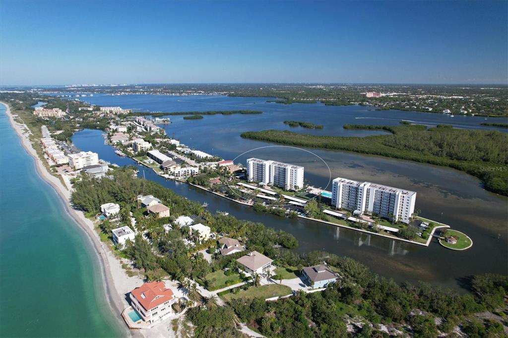 9393 Midnight Pass Road, Unit 302 Sarasota, FL 34242 - Photo 64 of 65 an aerial view of a house with a lake view