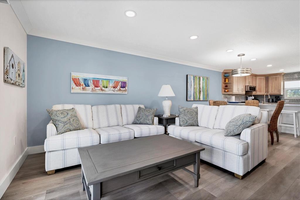9393 Midnight Pass Road, Unit 302 Sarasota, FL 34242 - Photo 7 of 65 a living room with furniture and a view of kitchen
