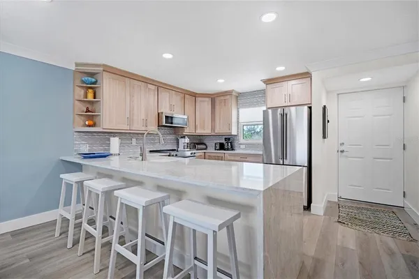 a kitchen with granite countertop cabinets and steel stainless steel appliances