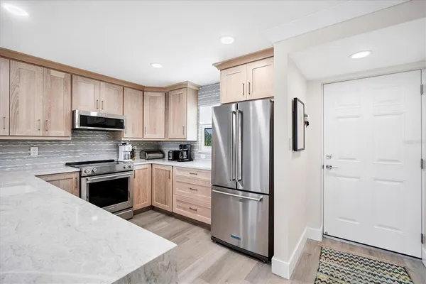 a kitchen with a sink stove and microwave