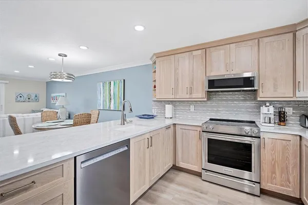 a kitchen with granite countertop white cabinets stainless steel appliances and sink