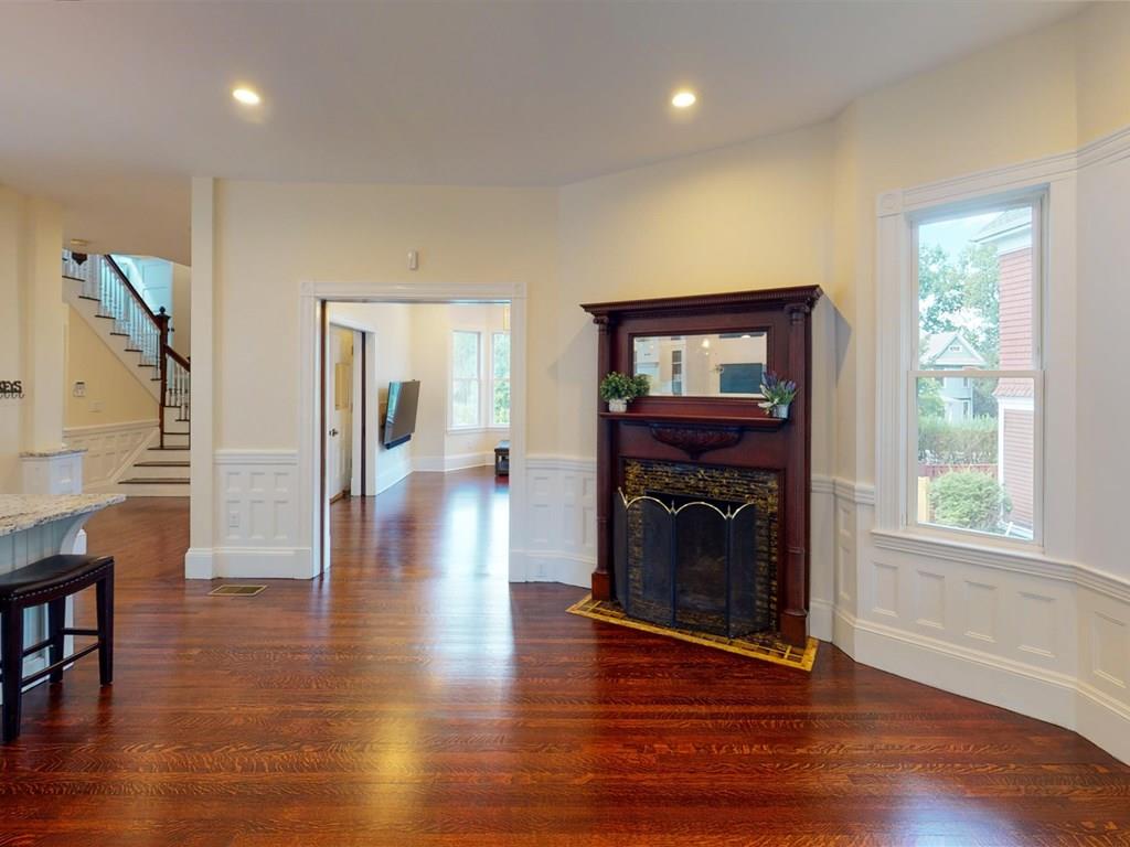 6 Kennard Road Brookline, MA 02445 - Photo 14 of 39 a view of a livingroom with wooden floor and a fireplace