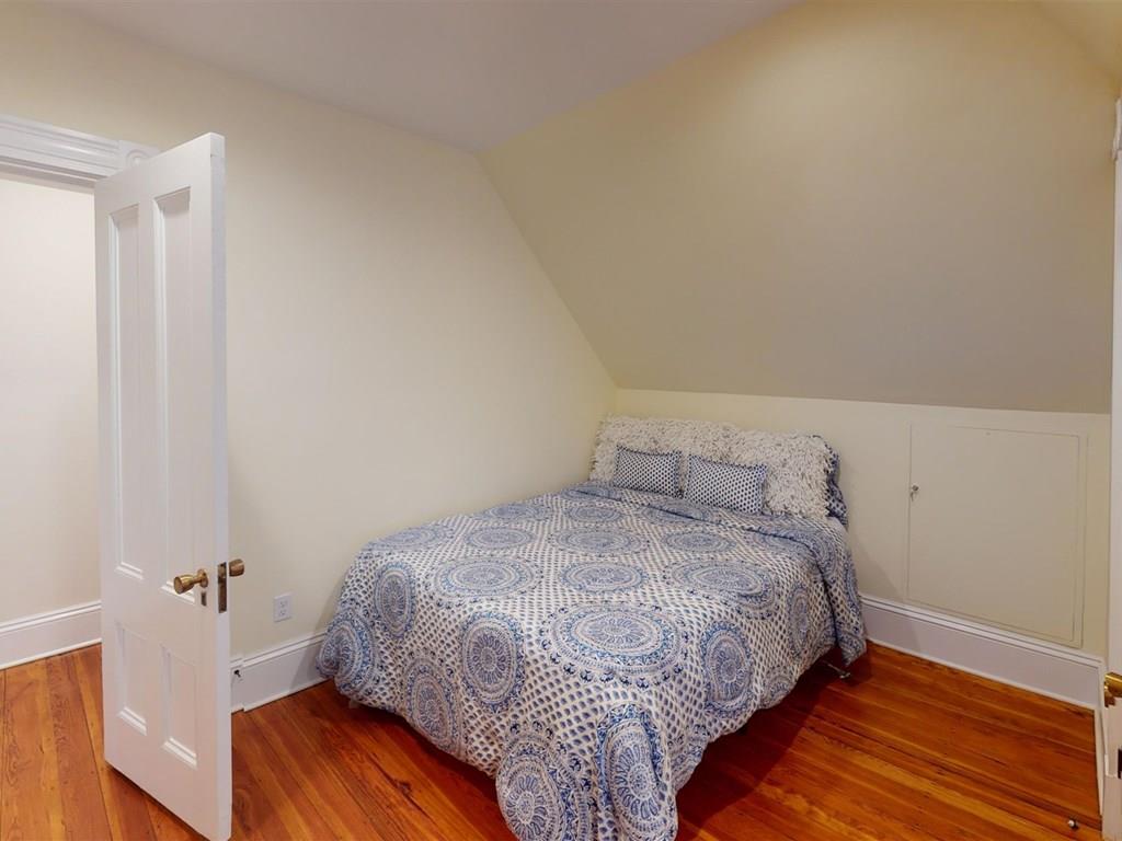 6 Kennard Road Brookline, MA 02445 - Photo 26 of 39 a bedroom with a bed and wooden floor