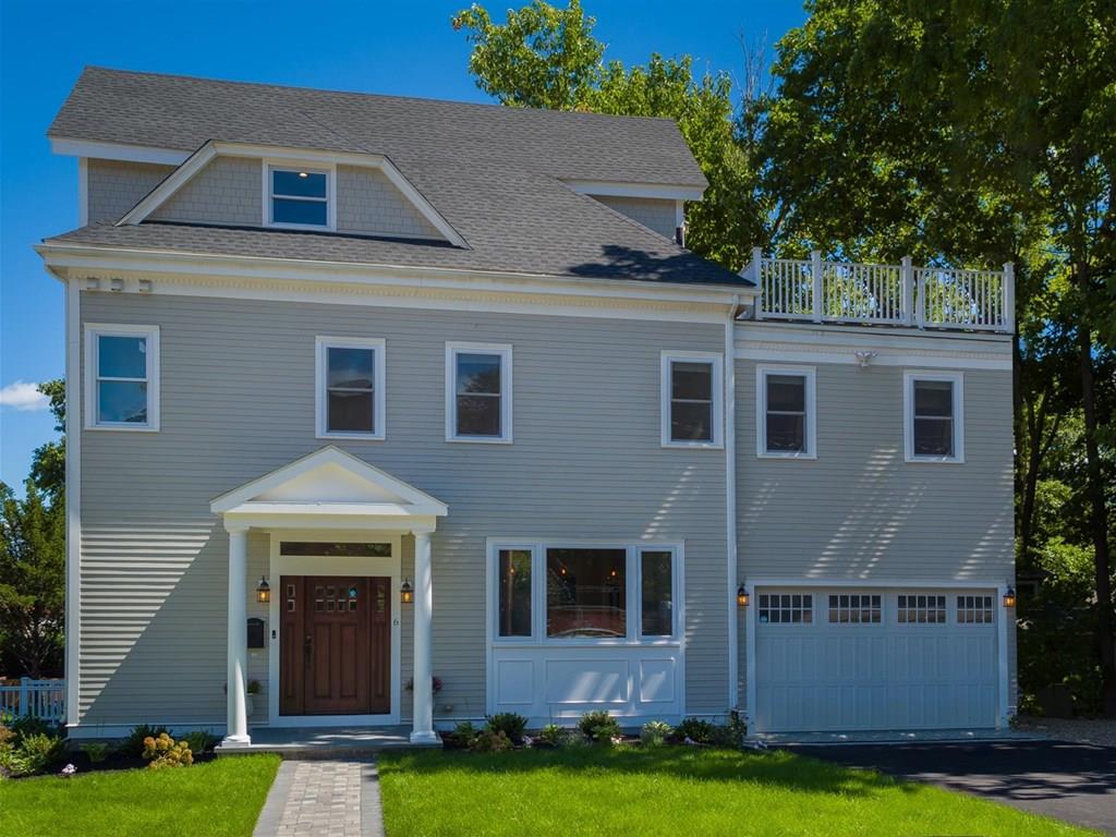 6 Kennard Road Brookline, MA 02445 - Photo 29 of 39 a front view of a house with a yard and garage