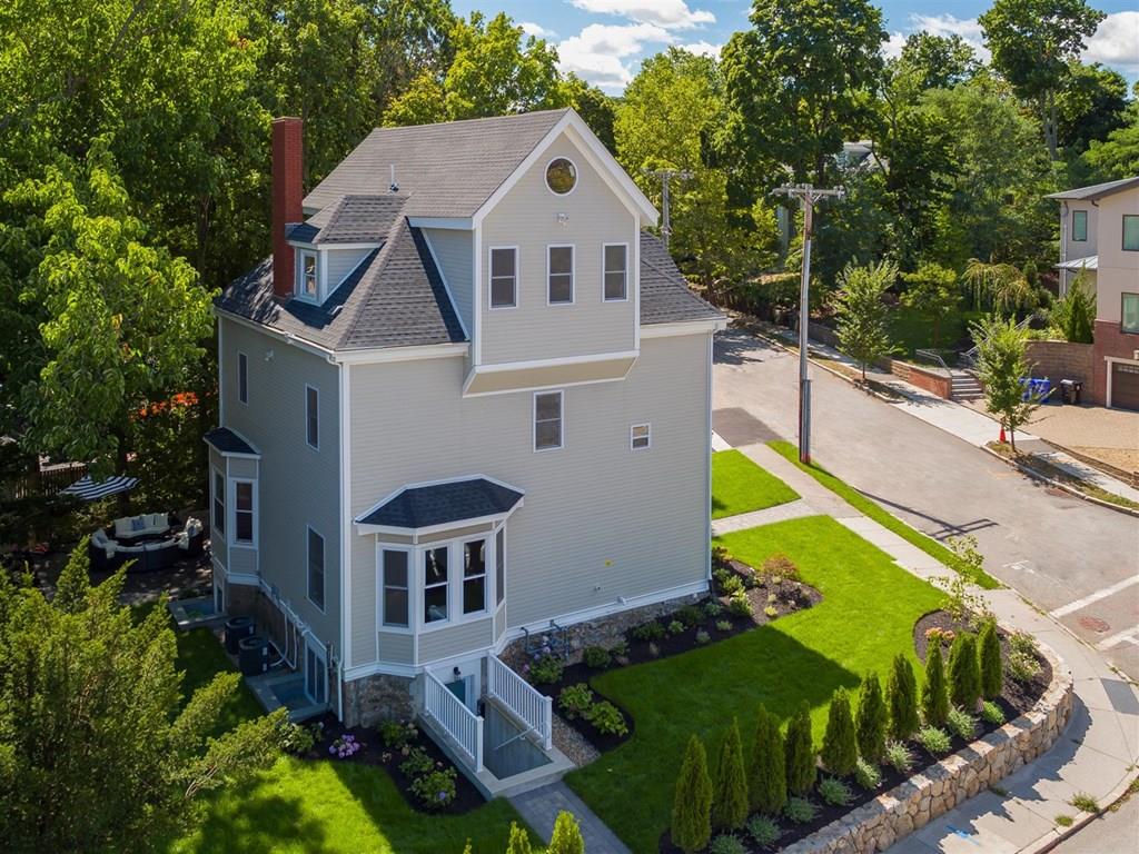 6 Kennard Road Brookline, MA 02445 - Photo 3 of 39 a aerial view of a house with swimming pool next to a yard