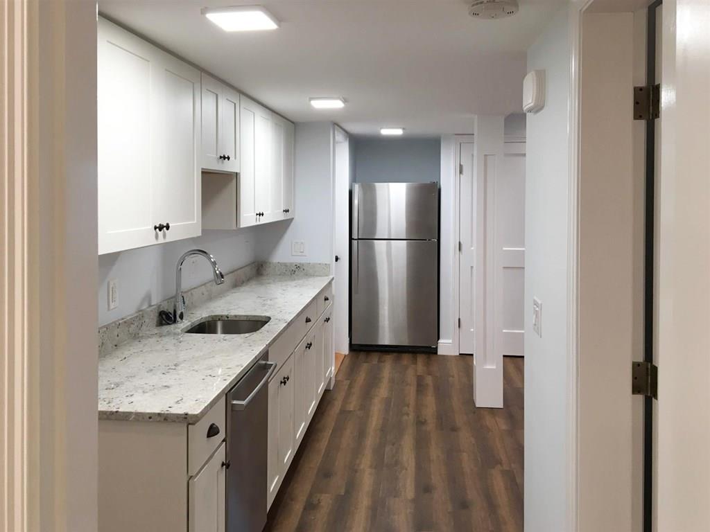 6 Kennard Road Brookline, MA 02445 - Photo 34 of 39 a kitchen with a sink stove and refrigerator