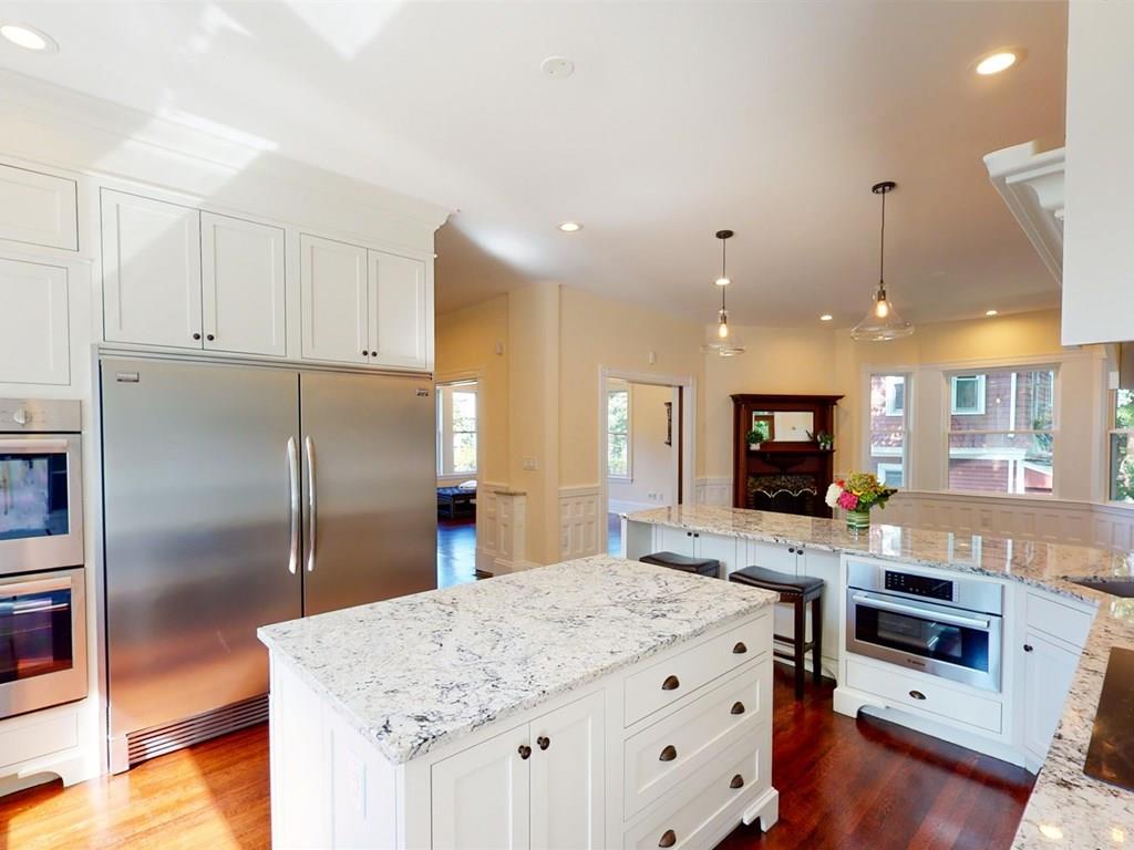 6 Kennard Road Brookline, MA 02445 - Photo 10 of 39 a kitchen with stainless steel appliances granite countertop a refrigerator a sink and a stove