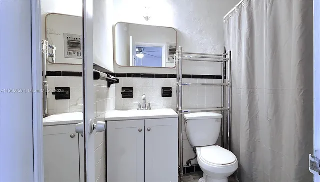 a bathroom with a toilet a sink and mirror