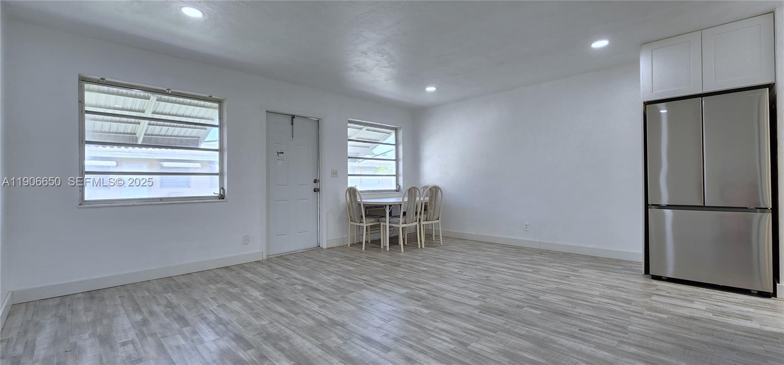 2901 Polk Street, Unit 14 Hollywood, FL 33020 - Photo 3 of 16 a view of empty room with wooden floor and a window