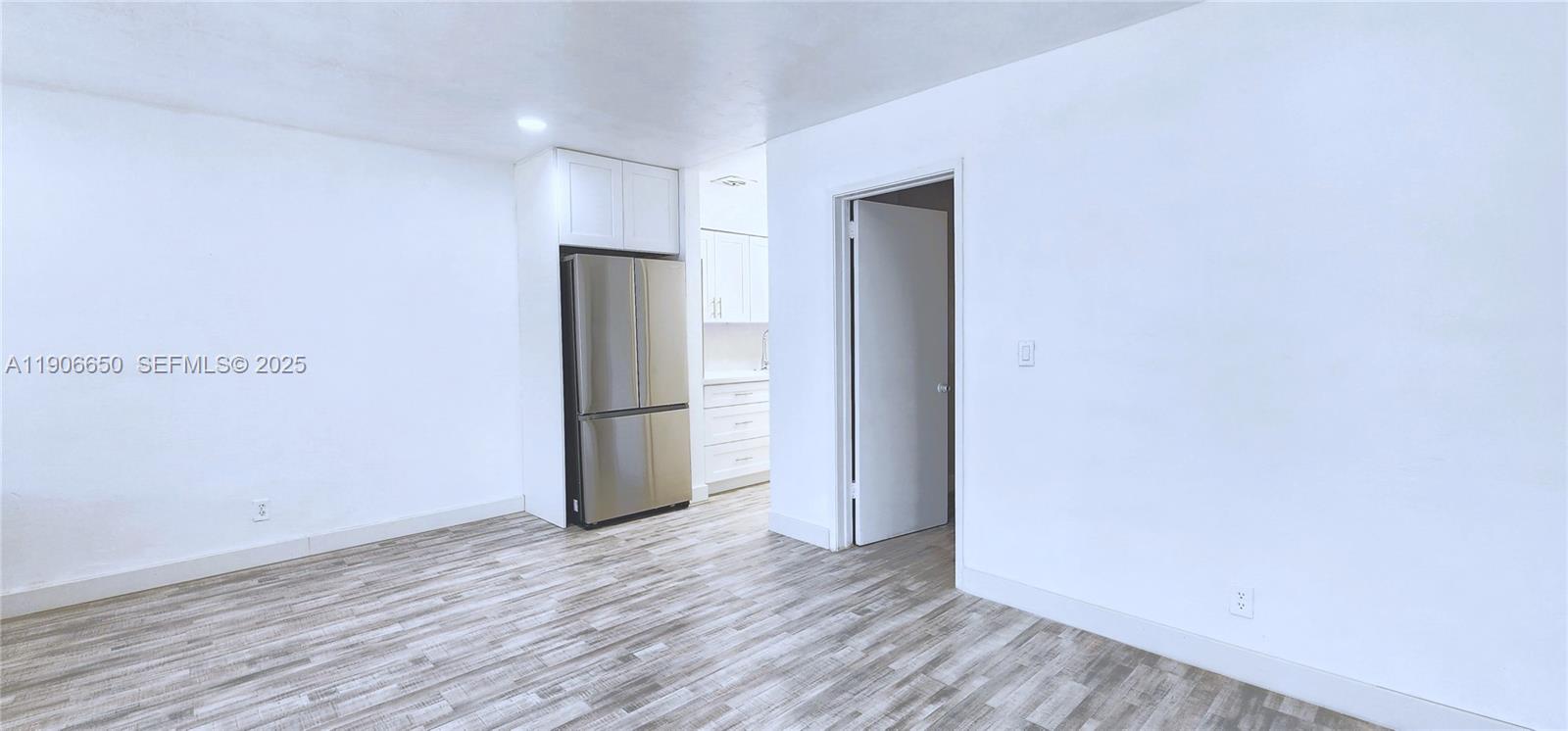 2901 Polk Street, Unit 14 Hollywood, FL 33020 - Photo 4 of 16 a view of an empty room with wooden floor and closet