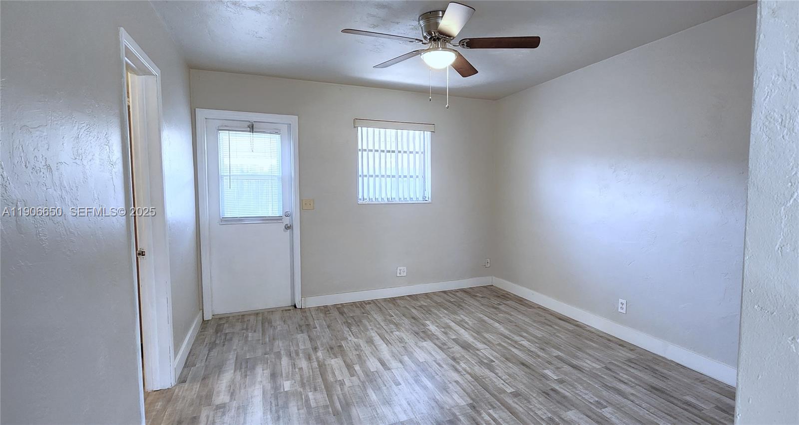 2901 Polk Street, Unit 14 Hollywood, FL 33020 - Photo 10 of 16 wooden floor in an empty room with a window