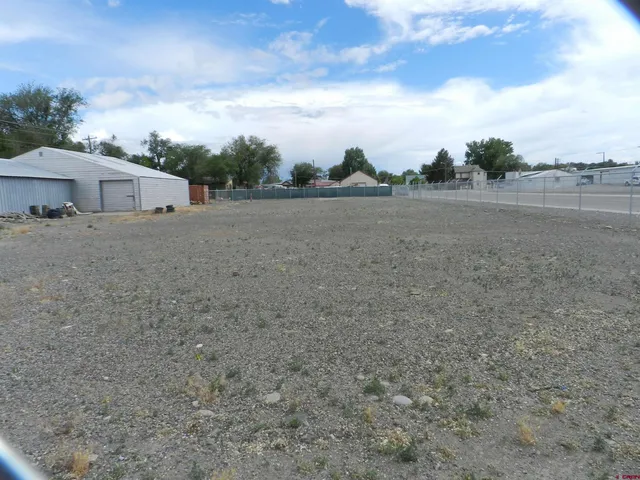 a view of dirt yard with a barn