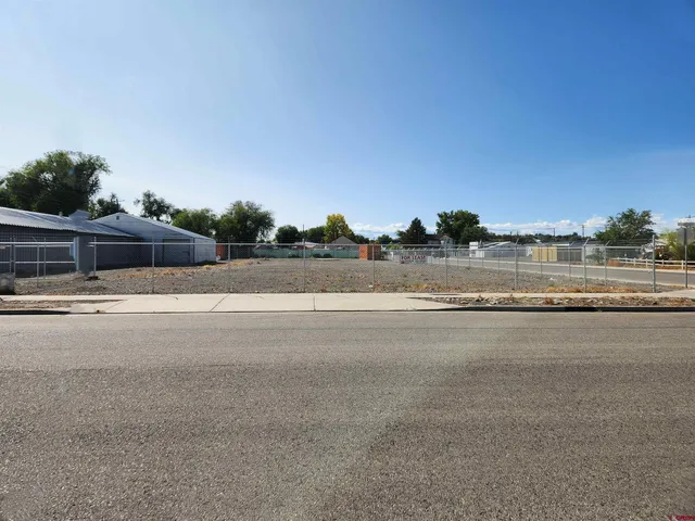 a view of a road with a building in the background