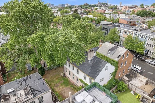 an aerial view of a house with a yard