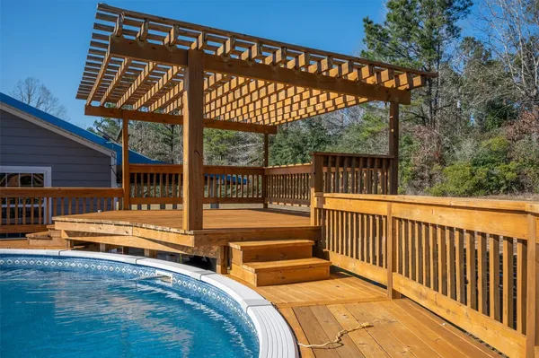 a view of a swimming pool with a deck