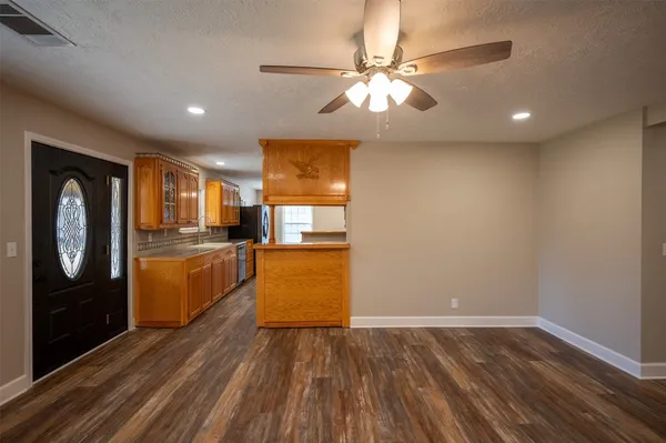 a kitchen with stainless steel appliances granite countertop a sink a stove and a refrigerator