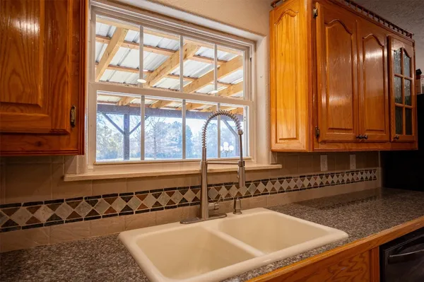 a kitchen with stainless steel appliances granite countertop a refrigerator a sink and dishwasher