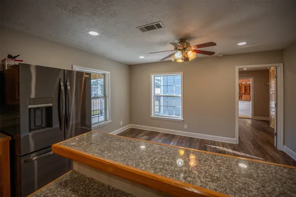 a view of a livingroom with wooden floor and window
