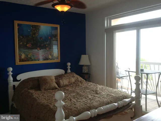 a bedroom with a bed and a painting on the wall