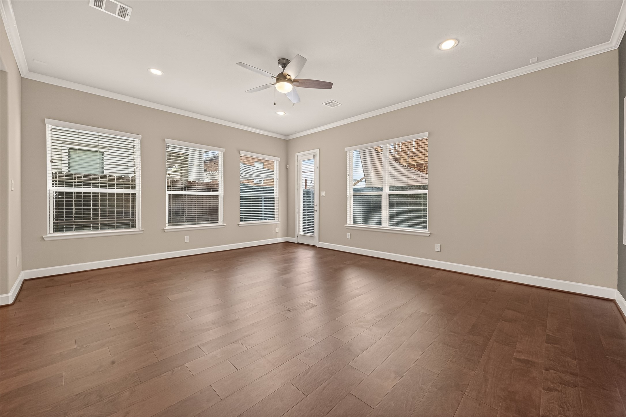 4413 Schuler Street, Unit B Houston, TX 77007 - Photo 13 of 46 a view of an empty room with wooden floor and windows