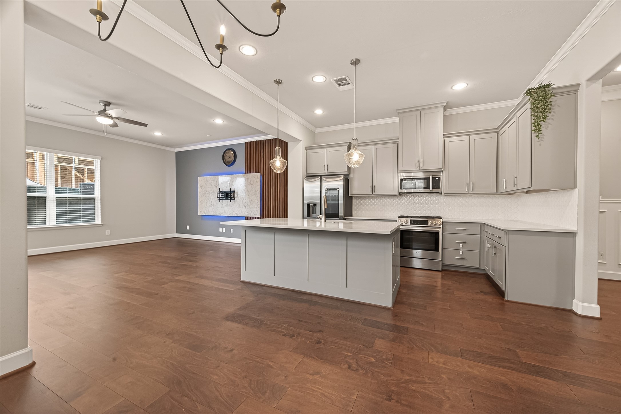4413 Schuler Street, Unit B Houston, TX 77007 - Photo 17 of 46 a large kitchen with kitchen island a sink stainless steel appliances and cabinets