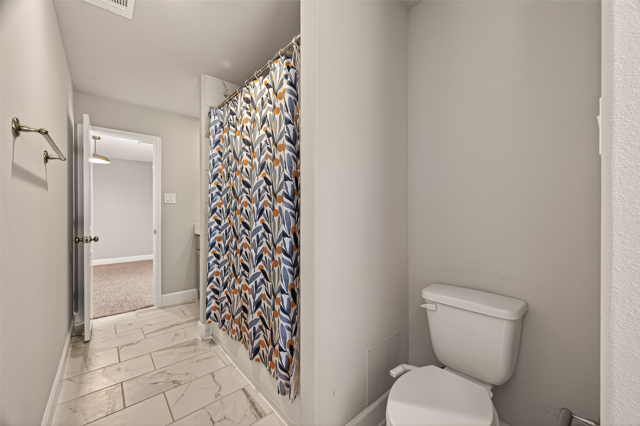 4413 Schuler Street, Unit B Houston, TX 77007 - Photo 30 of 46 a bathroom with a toilet and a shower curtain