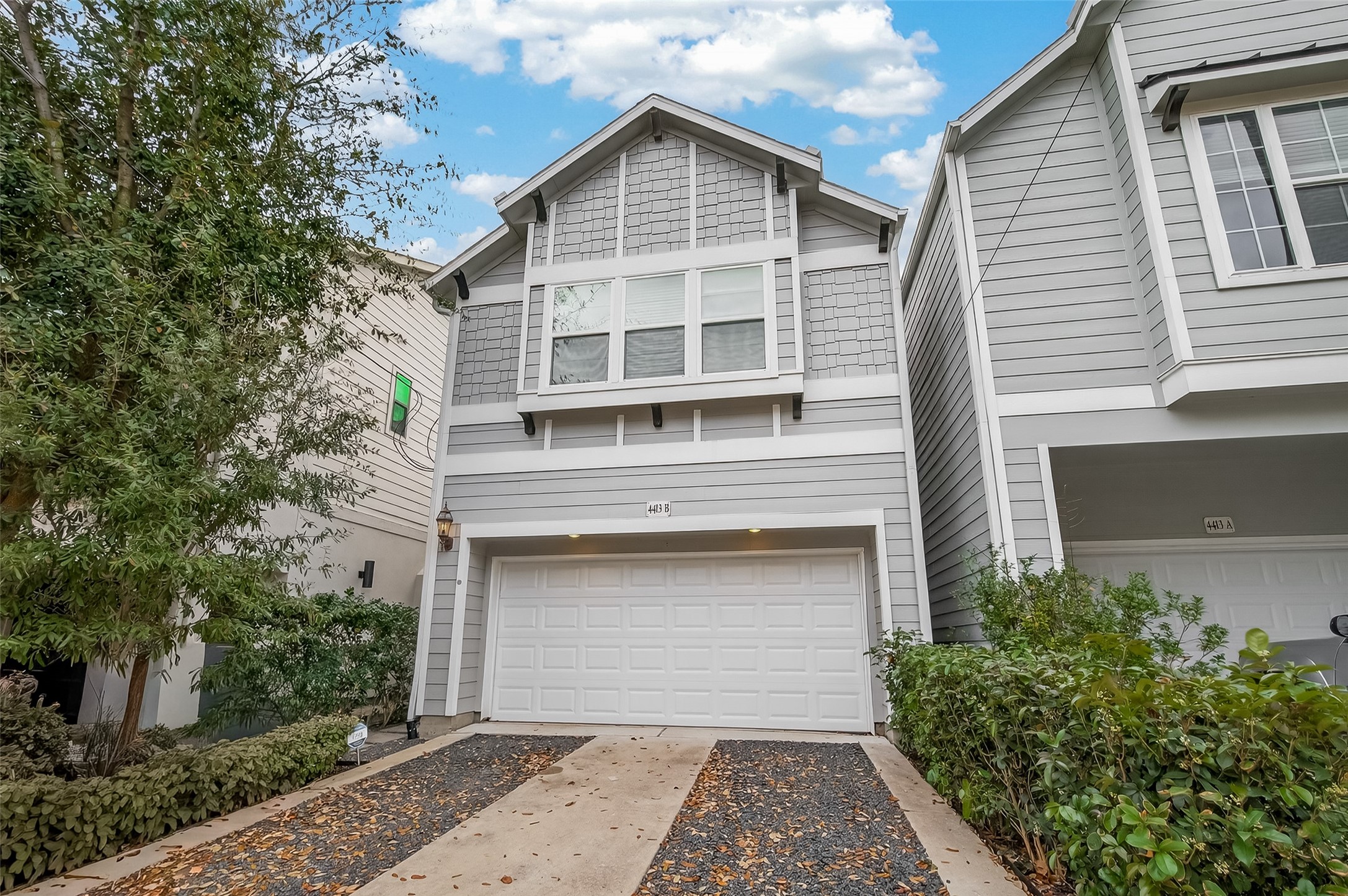 4413 Schuler Street, Unit B Houston, TX 77007 - Photo 3 of 46 a front view of a house with a yard and garage