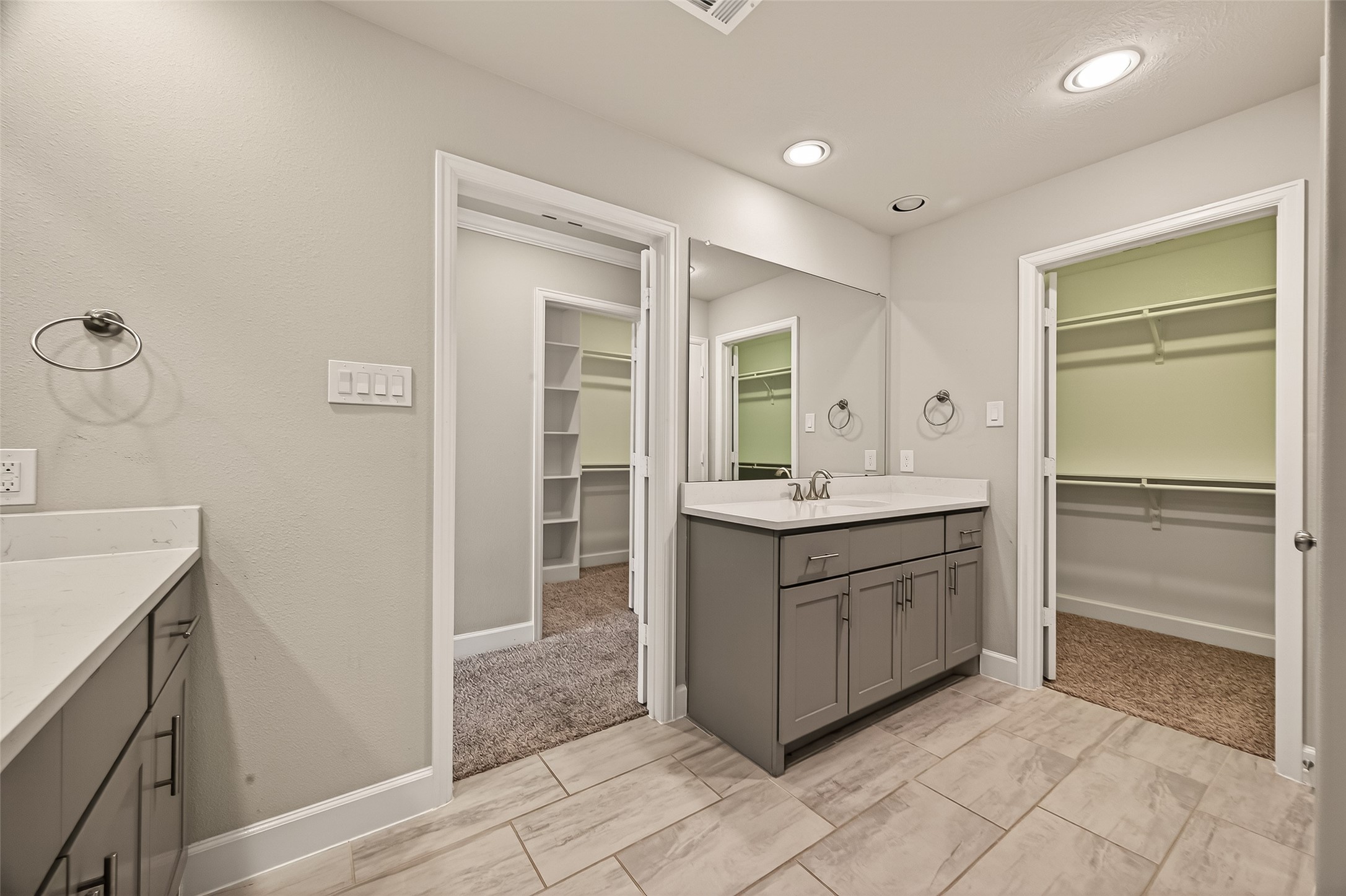 4413 Schuler Street, Unit B Houston, TX 77007 - Photo 40 of 46 a bathroom with a granite countertop sink mirror and cabinets