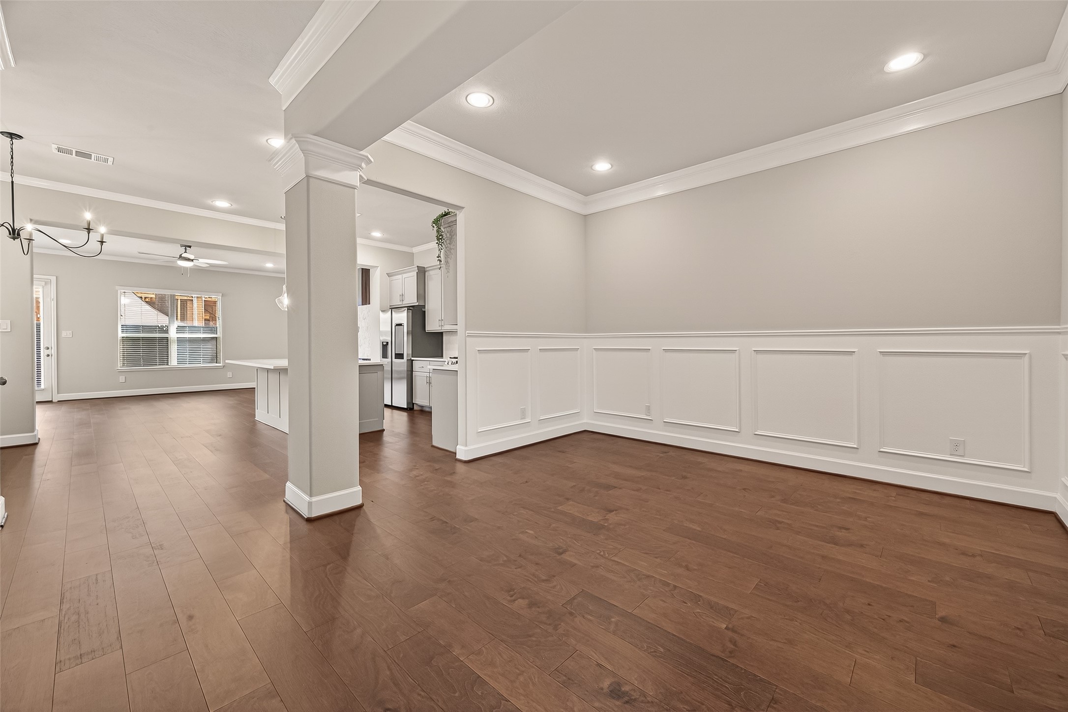 4413 Schuler Street, Unit B Houston, TX 77007 - Photo 9 of 46 a view of an empty room with wooden floor and a kitchen