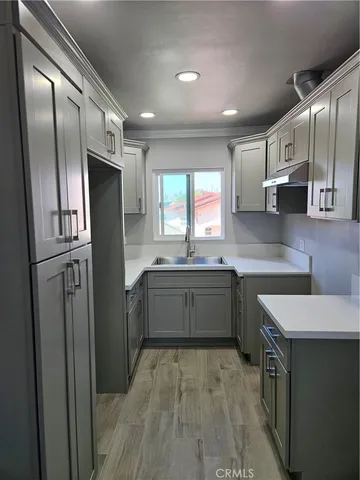 a kitchen with stainless steel appliances granite countertop a refrigerator a sink a stove and cabinets