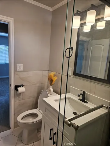 a bathroom with a sink toilet and mirror