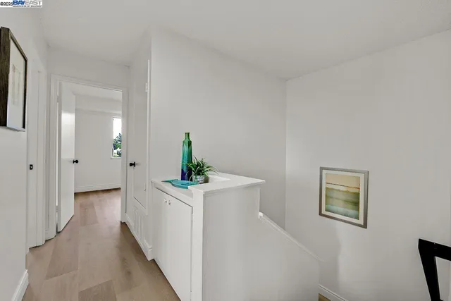 a view of hallway with sink and wooden floor