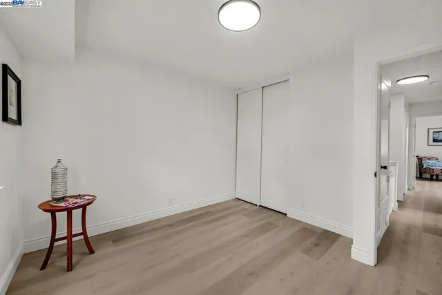 a view of a room with wooden floor and a sink