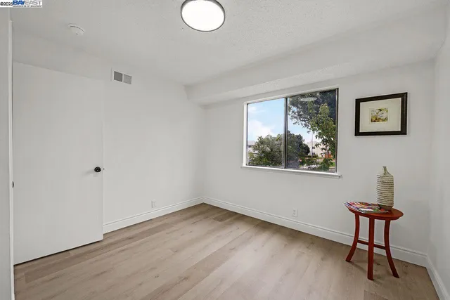 a view of a room with wooden floor and window