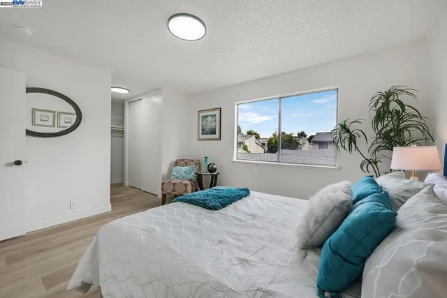 a bedroom with a large bed and a window