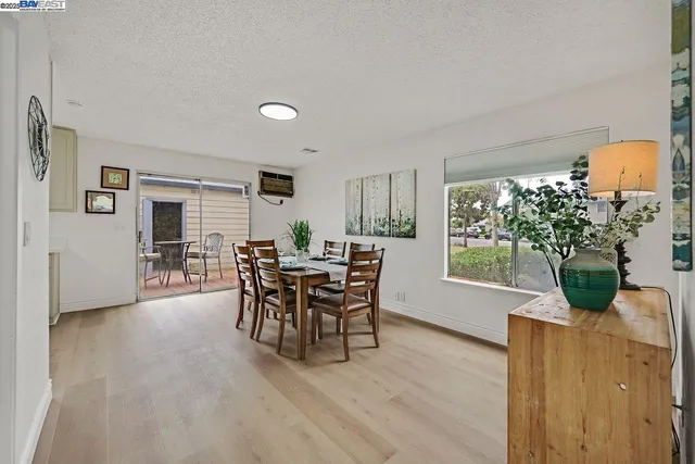 a dining room with furniture and wooden floor