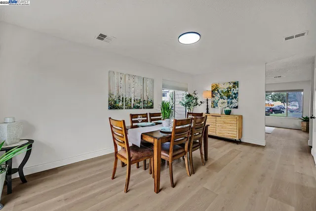 a dining room with furniture and wooden floor