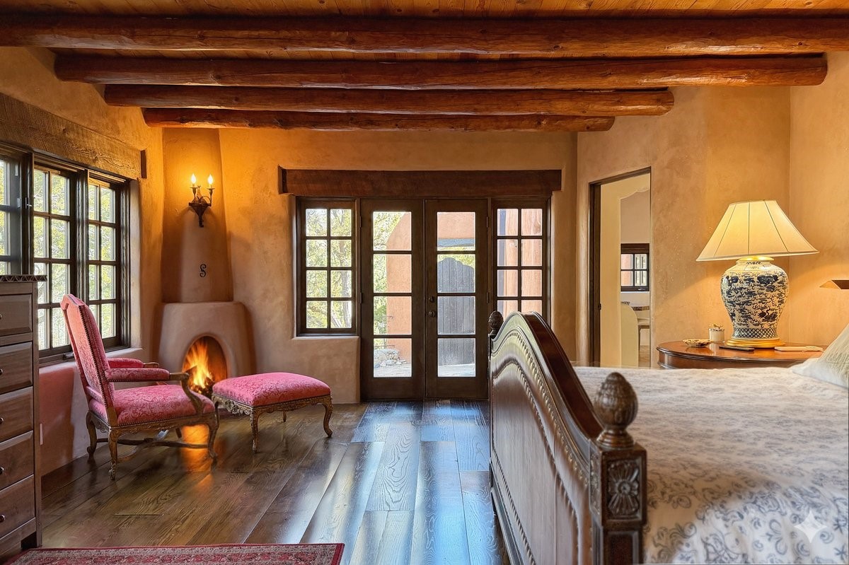1433 Upper Canyon Road Santa Fe, NM 87501 - Photo 25 of 57 Owner's Suite With Two Corner Kiva Fireplaces