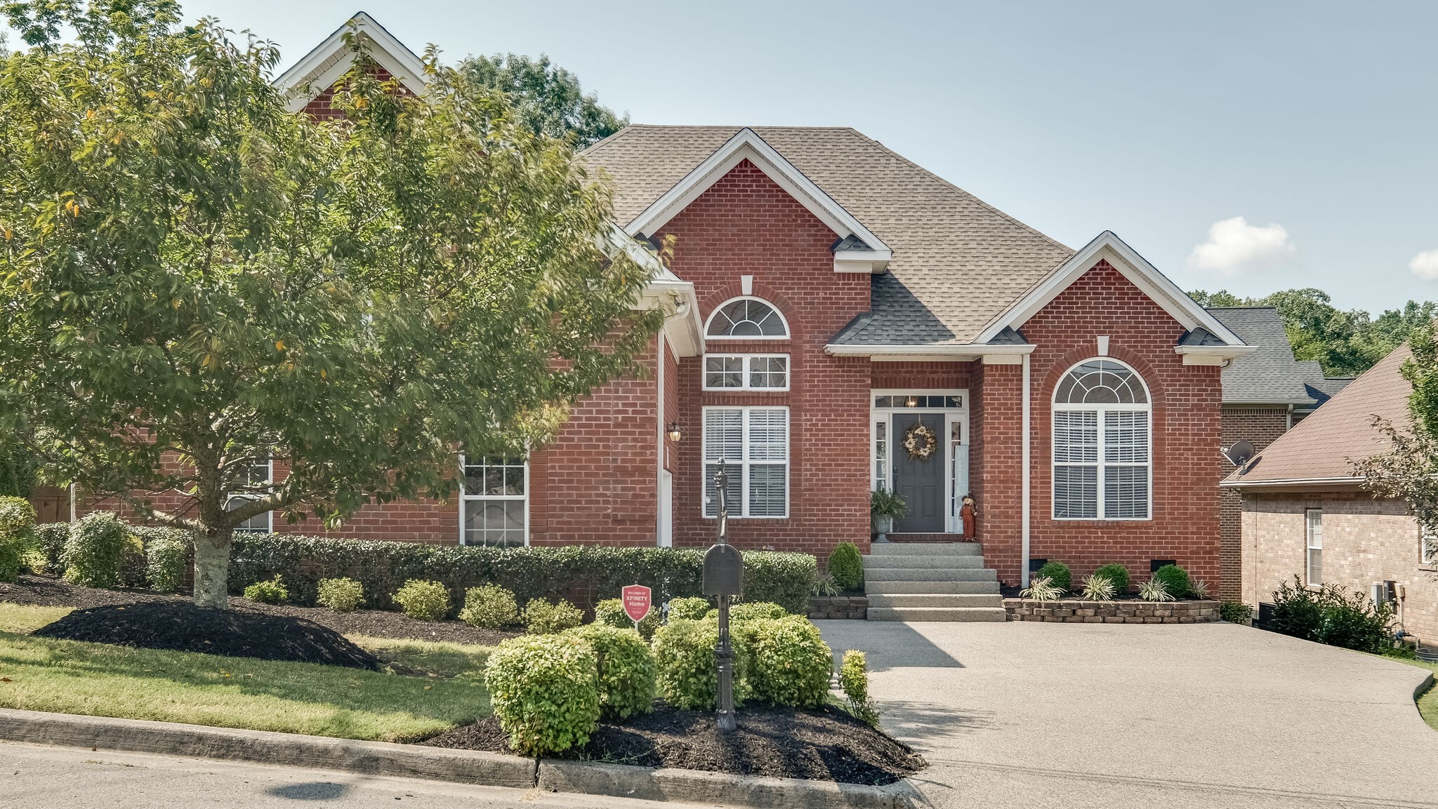 7005 Red Apple Road Antioch, TN 37013 - Photo 1 of 25 a front view of a house with a garden