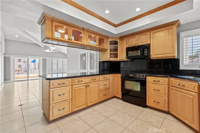 a kitchen with granite countertop a stove a sink and a cabinets