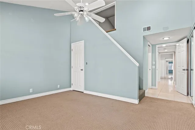 a view of an empty room with a ceiling fan