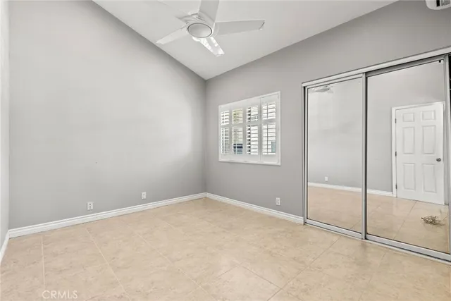 an empty room with windows and closet