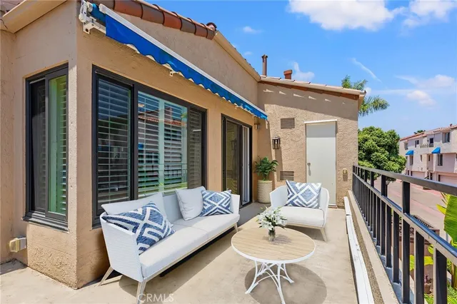 a balcony with furniture and a potted plant