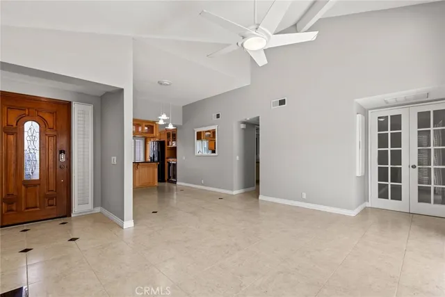 an empty room with closet and a ceiling fan