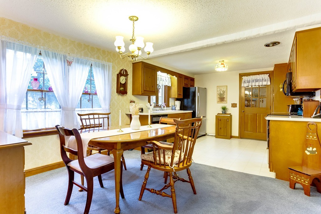 11 Newton Road Springfield, MA 01118 - Photo 8 of 30 a view of a dining room with furniture and a chandelier