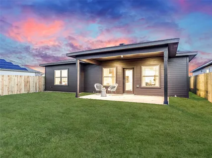 a view of a house with a yard and a garden